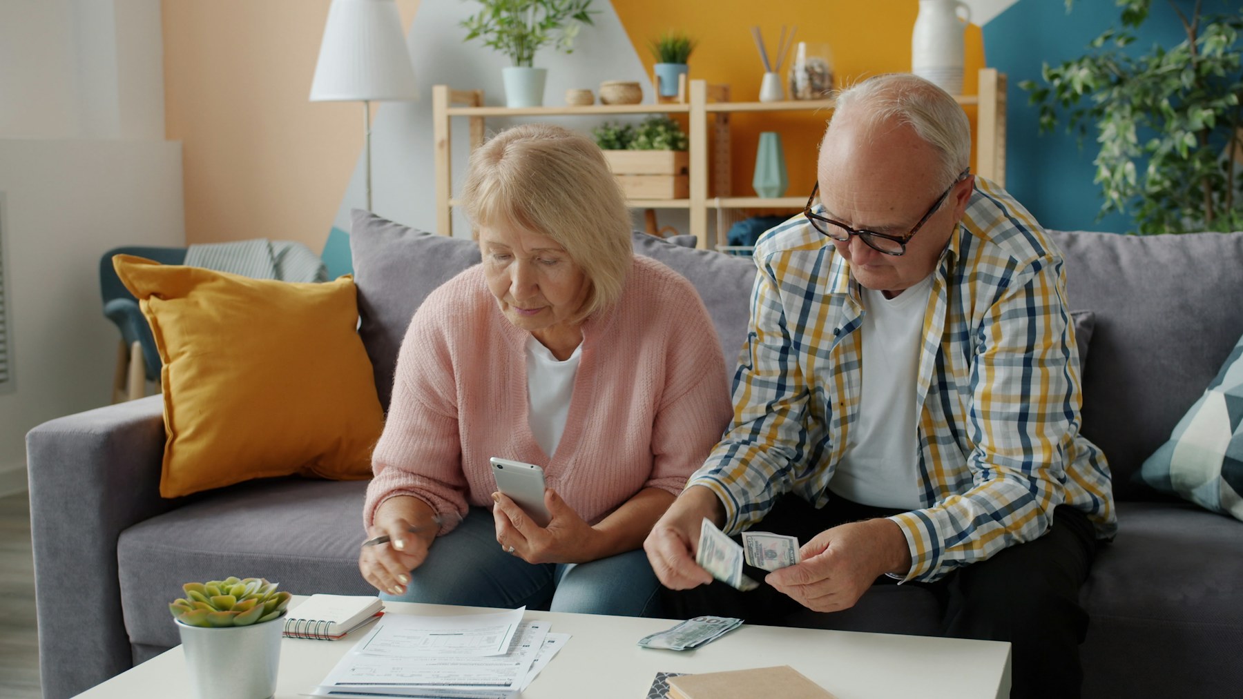 Couple reviewing household finances and retirement planning documents