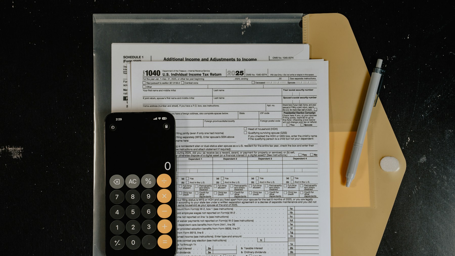 Calculator and pen on tax documents